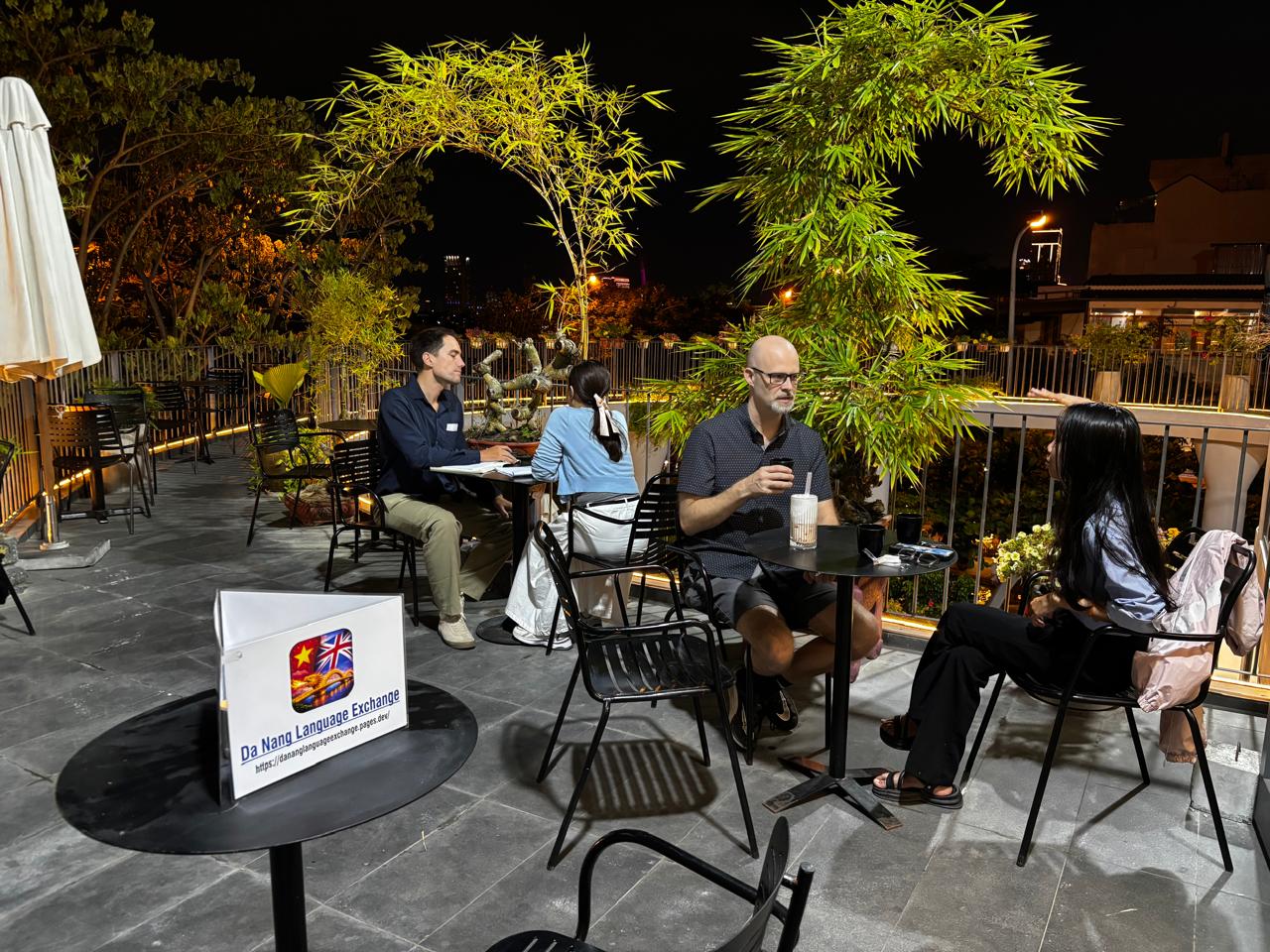 Small outdoor conversation tables during the Friday, May 1, 2026 Da Nang Language Exchange meetup.